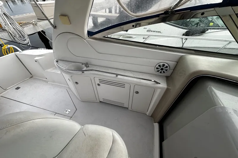 Slide: The Image of Interior of a 2001 Sea Ray 380 Sundancer boat, featuring seating and storage. - 19