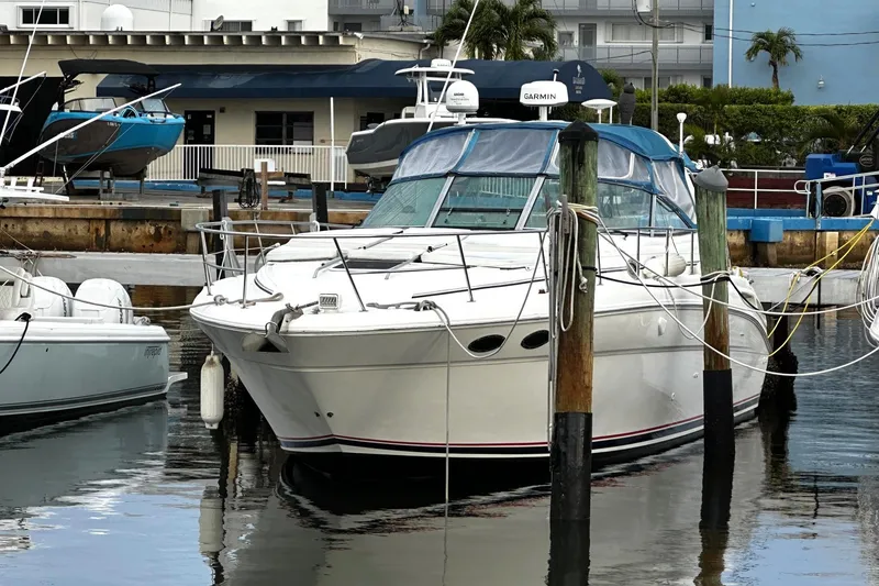 Slide: The Image of 2001 Sea Ray 380 Sundancer yacht docked at marina, surrounded by other boats. - 2