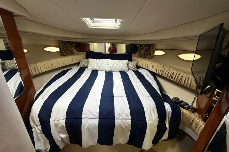 Slide: The Image of Luxurious cabin interior of 2001 Sea Ray 380 Sundancer with striped bedding. - 21