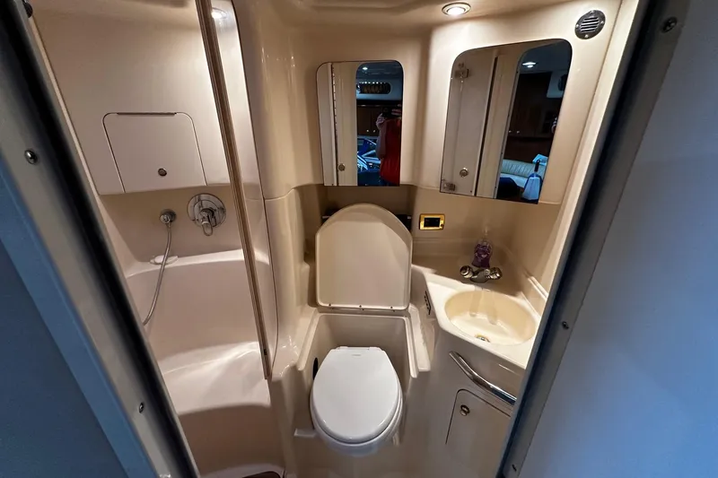 Slide: The Image of Bathroom interior of 2001 Sea Ray 380 Sundancer yacht, featuring shower, toilet, and sink. - 24