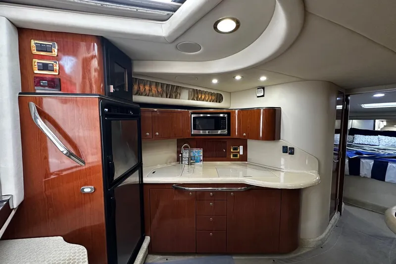 Slide: The Image of 2001 Sea Ray 380 Sundancer yacht interior with kitchenette and modern amenities. - 27