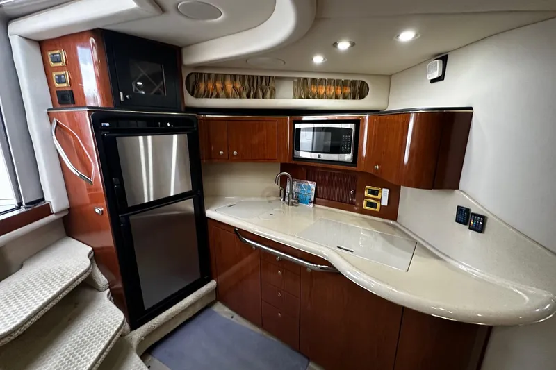 Slide: The Image of Luxurious 2001 Sea Ray 380 Sundancer yacht kitchen with modern appliances and elegant wood cabinetry. - 28