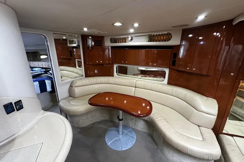 Slide: The Image of Luxurious interior of 2001 Sea Ray 380 Sundancer yacht with leather seating and wooden cabinetry. - 30