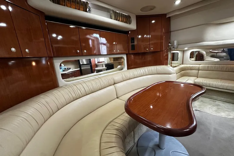 Slide: The Image of Luxurious interior of 2001 Sea Ray 380 Sundancer yacht with plush seating and wooden table. - 32