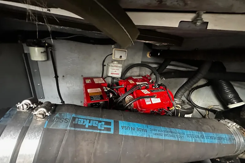 Slide: The Image of Engine compartment of a 2001 Sea Ray 380 Sundancer with visible red batteries and hoses. - 43