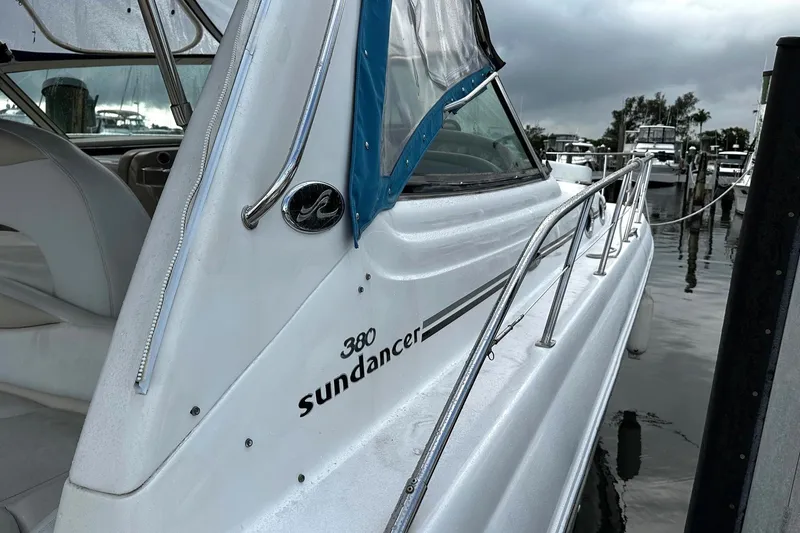 Slide: The Image of 2001 Sea Ray 380 Sundancer yacht docked, showcasing sleek design and polished exterior. - 44