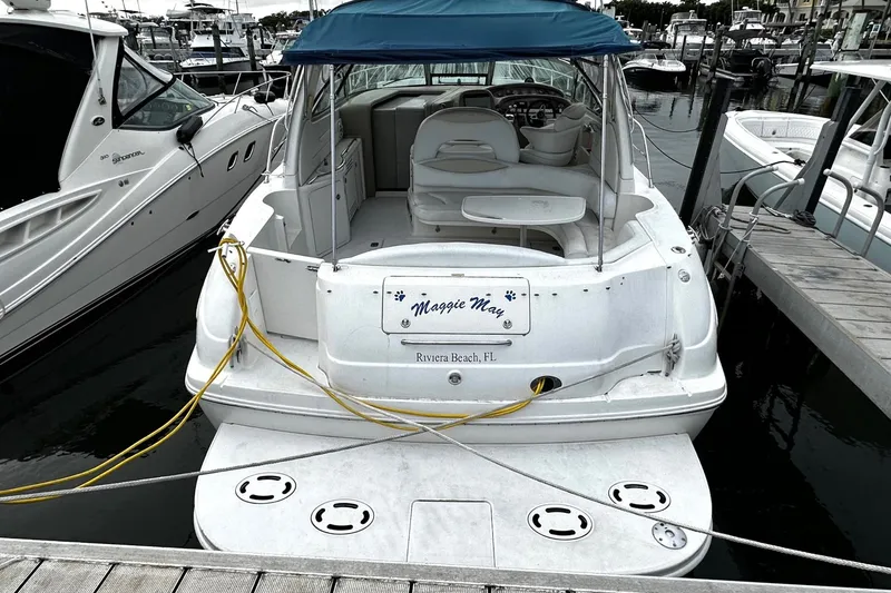 Slide: The Image of 2001 Sea Ray 380 Sundancer docked at marina, rear view with blue canopy. - 5