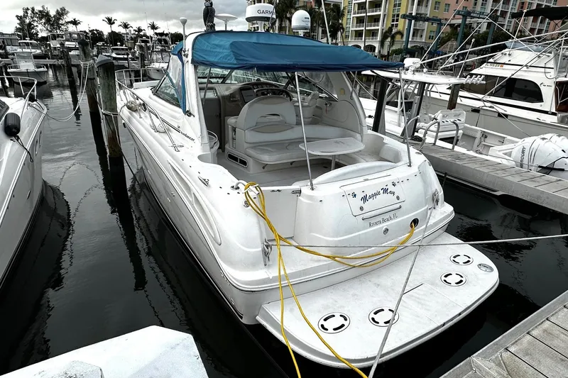 Slide: The Image of 2001 Sea Ray 380 Sundancer docked at marina with blue canopy. - 6