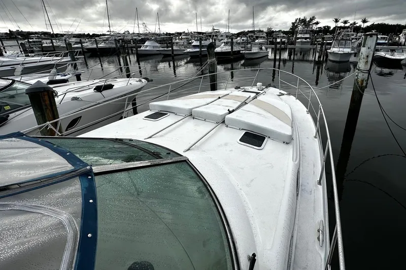 Slide: The Image of 2001 Sea Ray 380 Sundancer docked at marina under cloudy skies. - 8