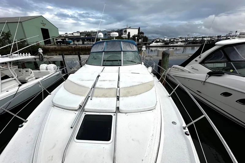 Slide: The Image of 2001 Sea Ray 380 Sundancer docked at marina, surrounded by other boats. - 9