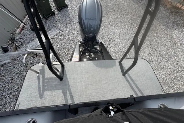 Slide: The Image of 2026 Veranda VISTA VIEW 22RC boat with motor and ladder on gravel surface. - 10