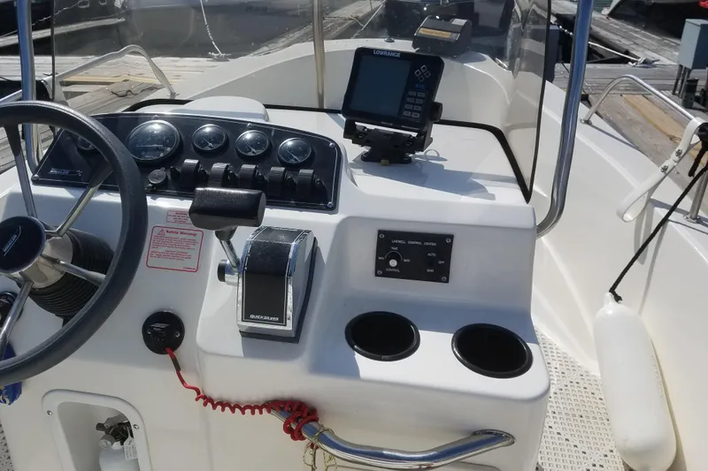 Slide: The Image of 1999 Boston Whaler 180 Dauntless boat console with steering wheel and navigation equipment. - 11