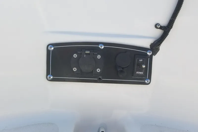 Slide: The Image of Control panel on a 1999 Boston Whaler 180 Dauntless boat, featuring switches and outlets. - 12