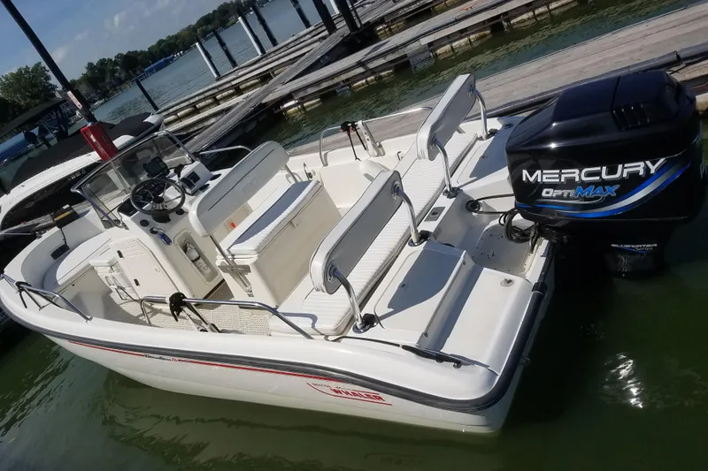 Slide: The Image of 1999 Boston Whaler 180 Dauntless boat docked with Mercury OptiMax engine. - 2