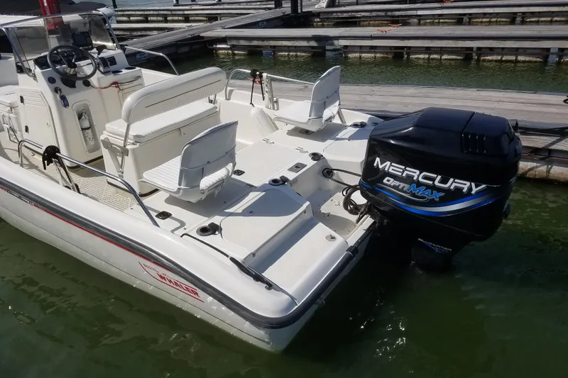 Slide: The Image of 1999 Boston Whaler 180 Dauntless boat with Mercury OptiMax engine at dock. - 8