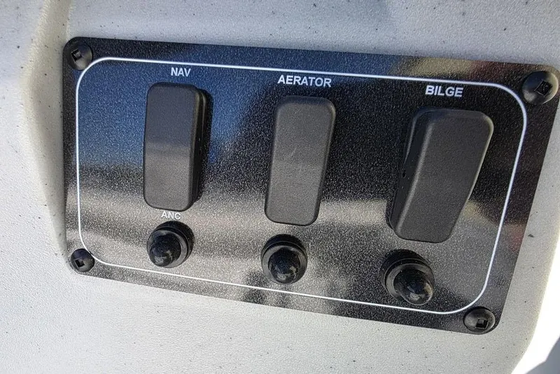 Slide: The Image of Control panel of 2026 Tracker Bass Tracker Classic CC boat with switches for navigation, aerator, bilge. - 12