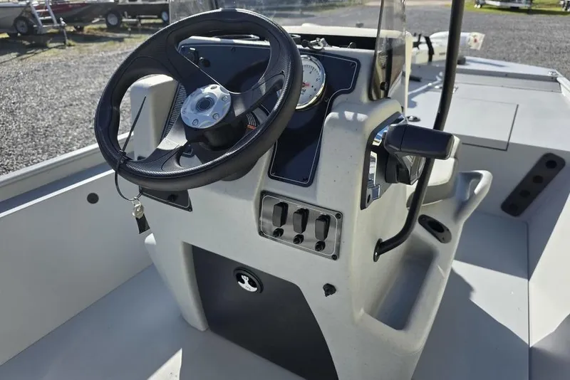 Slide: The Image of 2026 Tracker Bass Tracker Classic CC boat console with steering wheel and controls. - 13