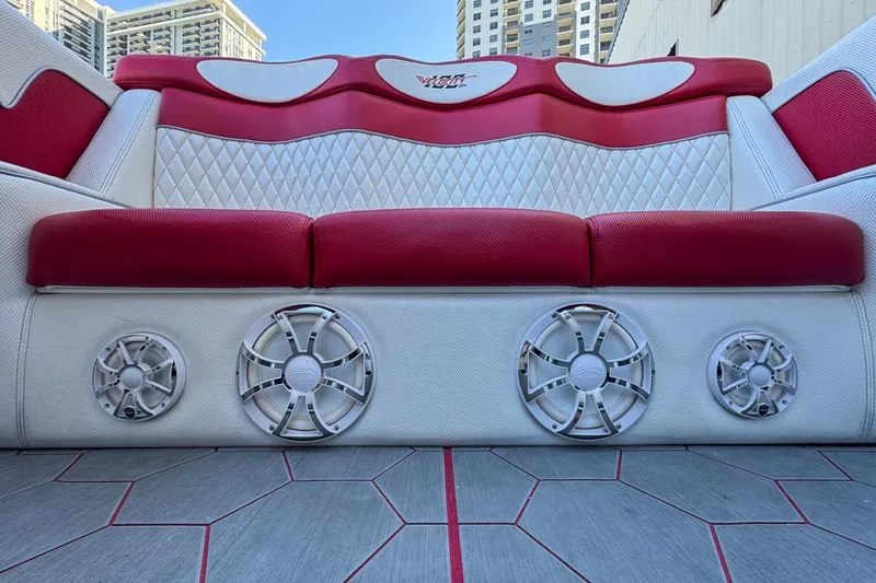 Slide: The Image of Red and white seating with speakers on a 2022 Velocity 290sc boat. - 103