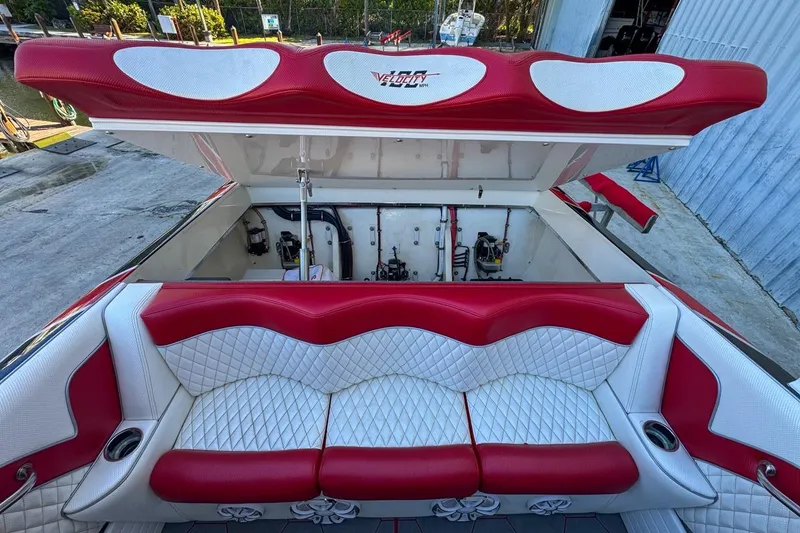 Slide: The Image of Red and white seating on 2022 Velocity 290sc boat, open engine compartment. - 104