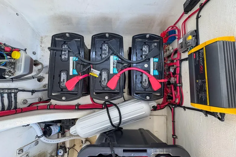 Slide: The Image of Battery compartment of 2022 Velocity 290sc boat with wiring and ProSport HD12 charger. - 106