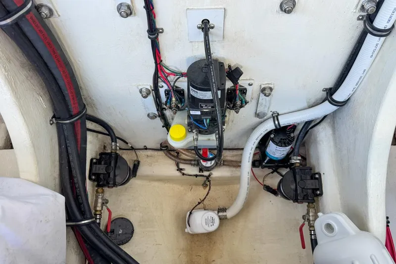 Slide: The Image of Engine compartment of a 2022 Velocity 290sc boat, showcasing wiring and components. - 109