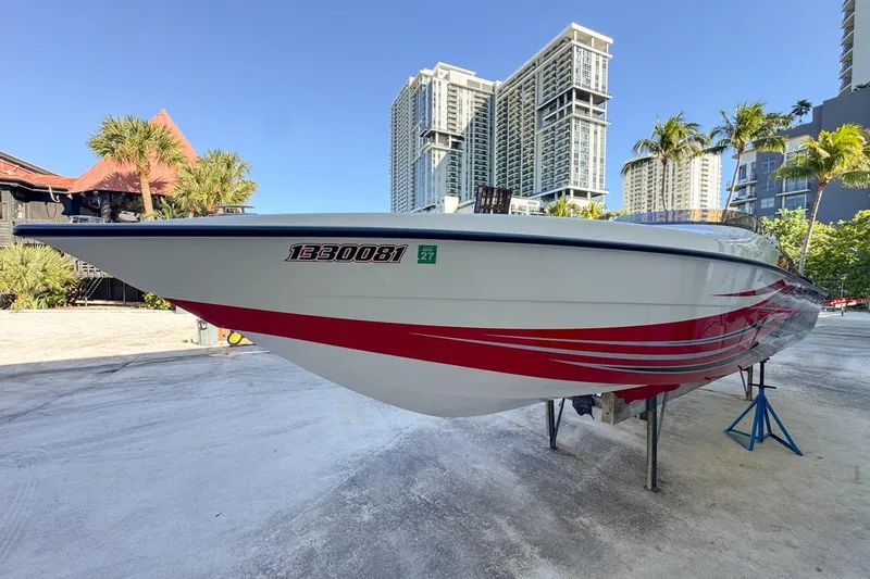 Slide: The Image of 2022 Velocity 290sc speedboat with red accents, docked near modern high-rise buildings. - 11