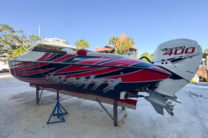 Slide: The Image of 2022 Velocity 290sc speedboat with Racing 400 engine, vibrant red and blue design. - 12