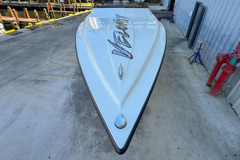 Slide: The Image of 2022 Velocity 290sc speedboat on concrete dock, showcasing sleek design and logo. - 15
