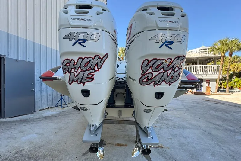 Slide: The Image of Twin Mercury Verado 400R engines on a 2022 Velocity 290SC boat, with custom graphics. - 20