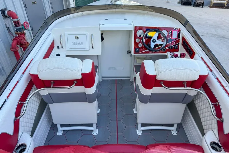 Slide: The Image of Interior of 2022 Velocity 290sc boat with red and white seating and modern dashboard. - 25