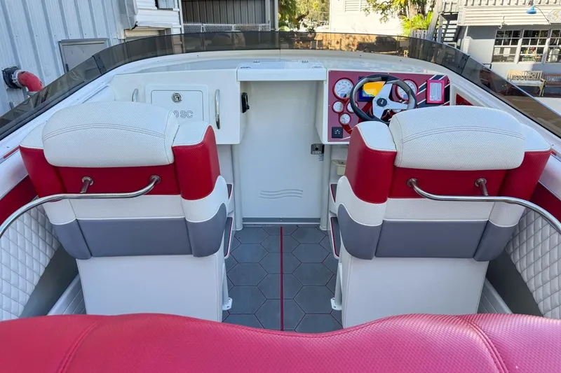 Slide: The Image of 2022 Velocity 290sc boat interior with red and white seating, modern dashboard, and steering wheel. - 26