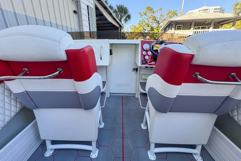 Slide: The Image of 2022 Velocity 290sc boat interior with red and white seating and modern dashboard. - 27