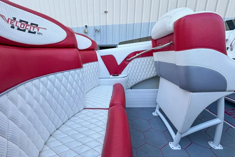 Slide: The Image of Red and white interior of 2022 Velocity 290sc boat with quilted seating. - 31