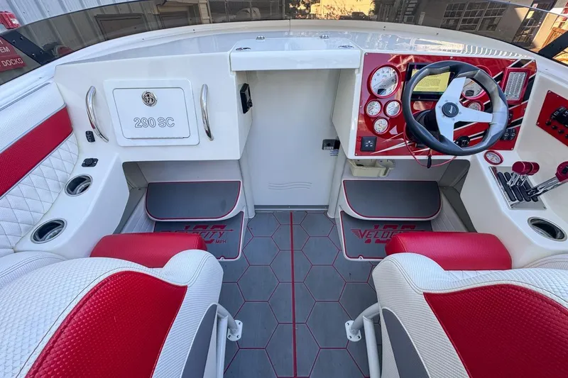 Slide: The Image of Cockpit of 2022 Velocity 290SC boat with red and white interior design. - 38