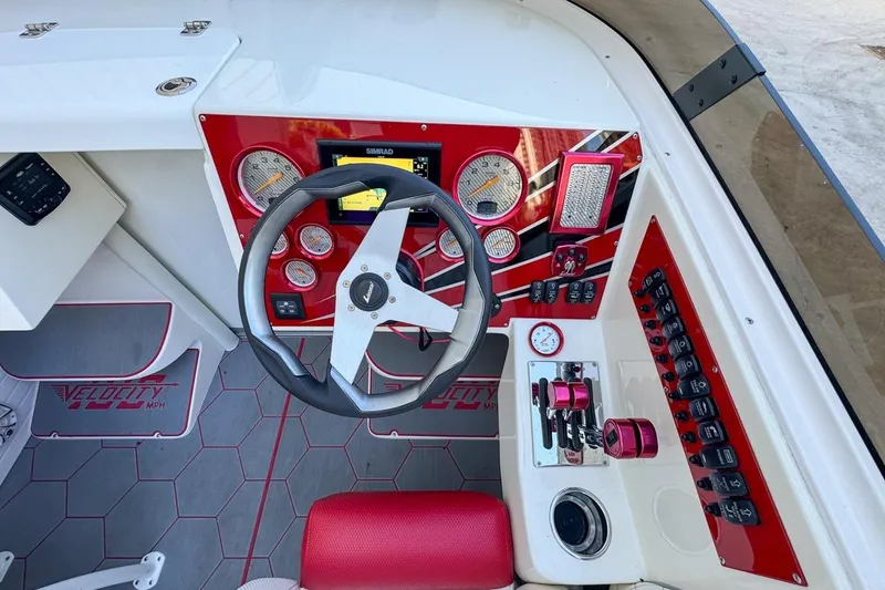 Slide: The Image of Cockpit of 2022 Velocity 290sc boat with red accents and modern controls. - 41