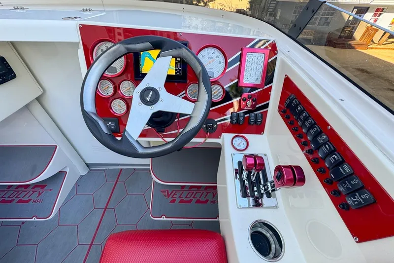 Slide: The Image of Cockpit of 2022 Velocity 290sc boat with red accents and modern controls. - 42