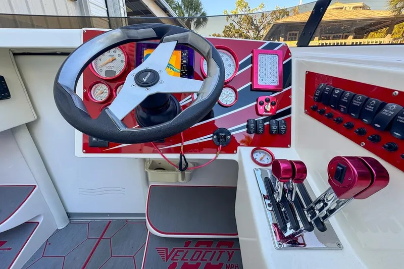 Slide: The Image of Cockpit of 2022 Velocity 290sc boat with steering wheel, gauges, and controls. - 43