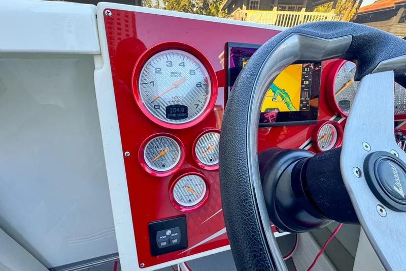 Slide: The Image of Dashboard of a 2022 Velocity 290sc boat with gauges and navigation screen. - 48