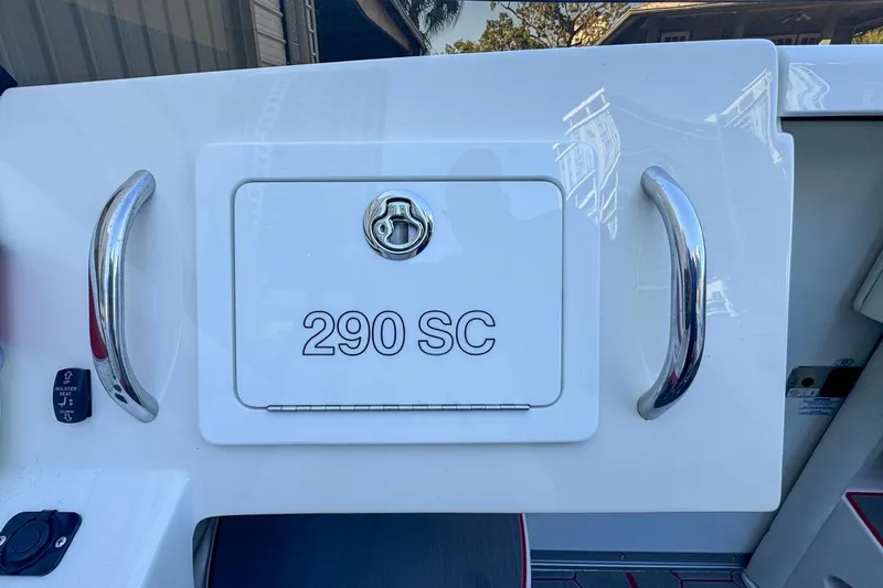 Slide: The Image of 2022 Velocity 290SC boat compartment with chrome handles and lock. - 49