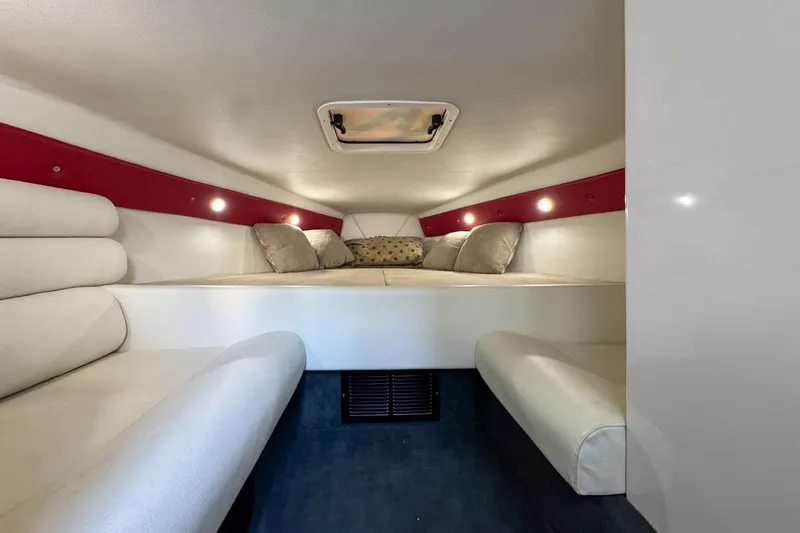 Slide: The Image of 2022 Velocity 290sc boat cabin interior with cozy seating and ambient lighting. - 57