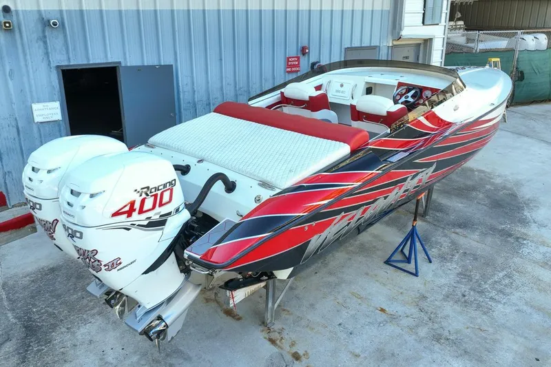 Slide: The Image of 2022 Velocity 290sc speedboat with twin 400 horsepower engines, vibrant red and black design. - 6