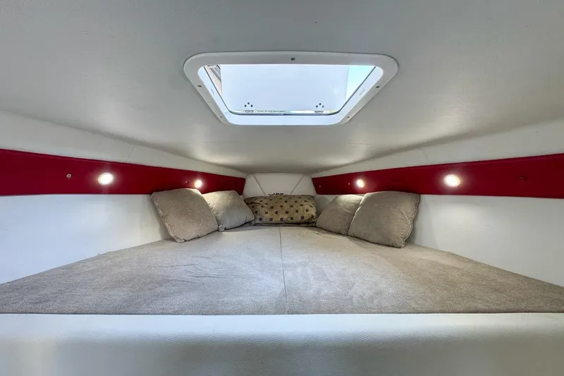 Slide: The Image of Cozy interior cabin of 2022 Velocity 290sc boat with skylight and cushions. - 64