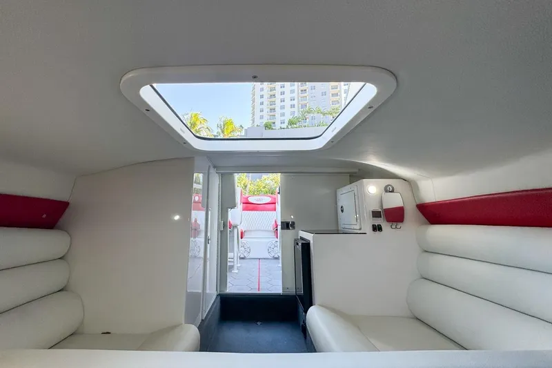 Slide: The Image of Interior of 2022 Velocity 290sc boat with white seating and skylight. - 70