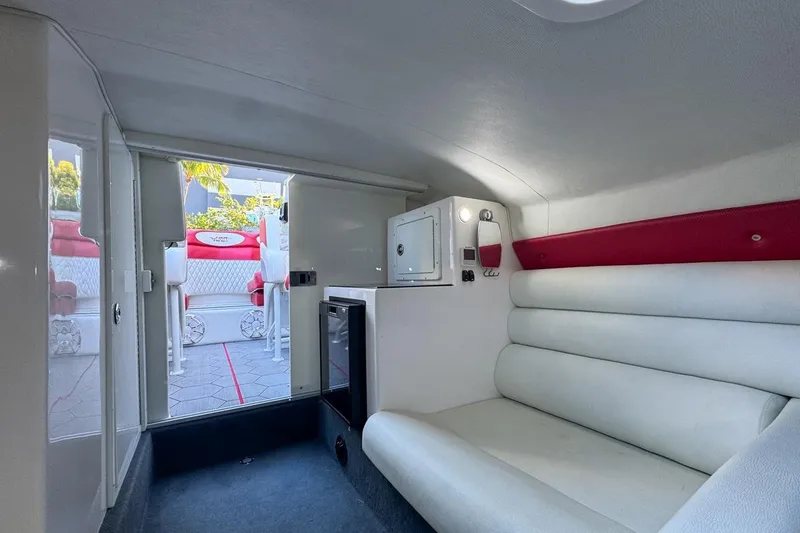 Slide: The Image of Interior of 2022 Velocity 290sc boat with white seating and compact cabin design. - 73