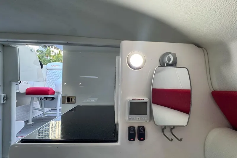 Slide: The Image of Interior of 2022 Velocity 290sc boat with control panel, mirror, and seating. - 75