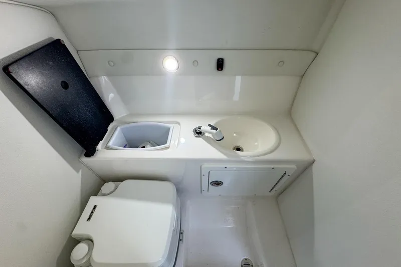 Slide: The Image of Compact bathroom in 2022 Velocity 290sc boat with sink and toilet. - 80
