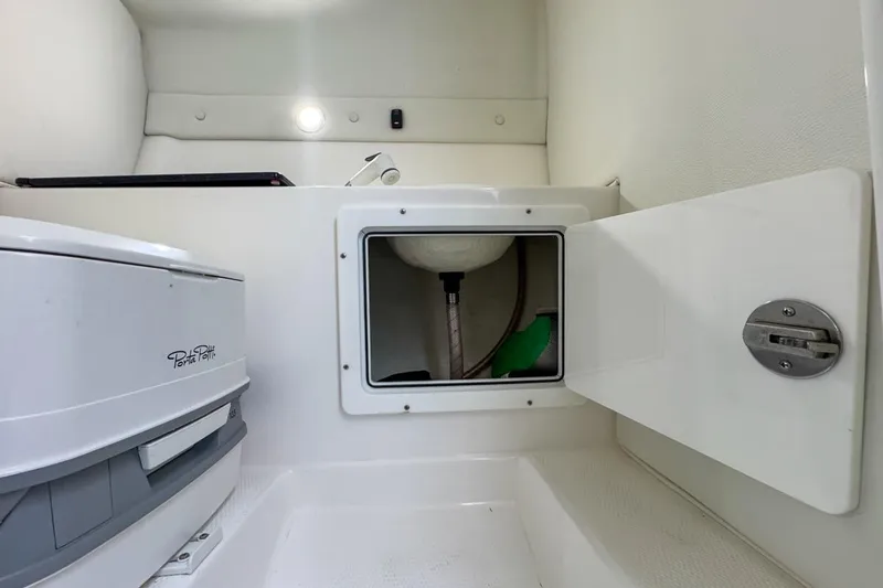 Slide: The Image of Interior of 2022 Velocity 290sc boat with Porta Potti and storage compartment. - 81