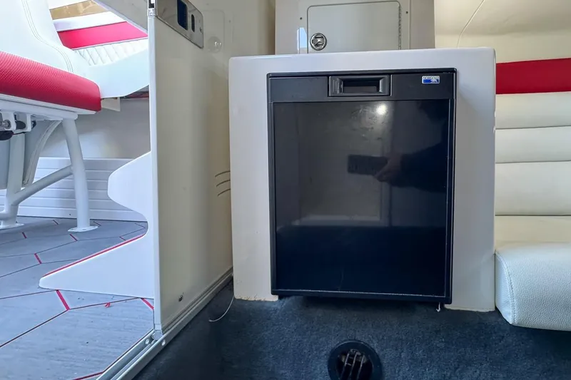 Slide: The Image of 2022 Velocity 290sc interior with compact fridge and seating area. - 83