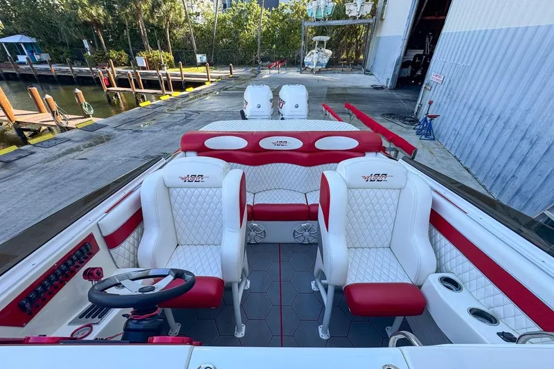 Slide: The Image of Interior of 2022 Velocity 290sc boat with red and white seating, dockside view. - 89