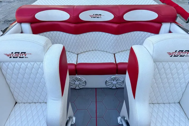 Slide: The Image of 2022 Velocity 290sc boat interior with red and white diamond-stitched seating. - 92